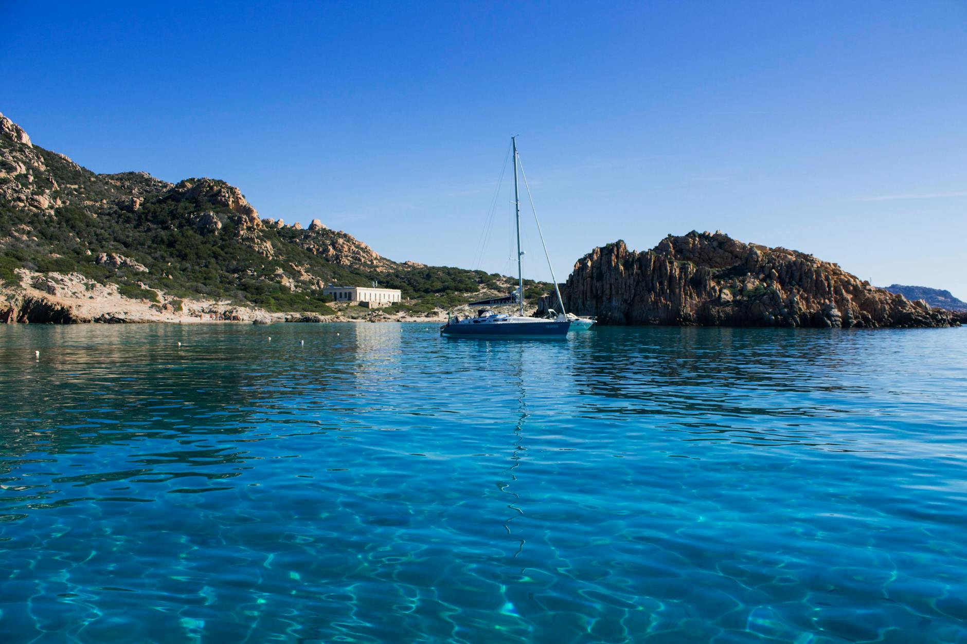 view of a sailboat on clea blue water in a lagoon