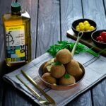 fried round food with celery on a frying pan